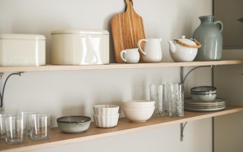 a shelf with dishes and teapots on it