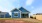 a blue house with a patio and lawn